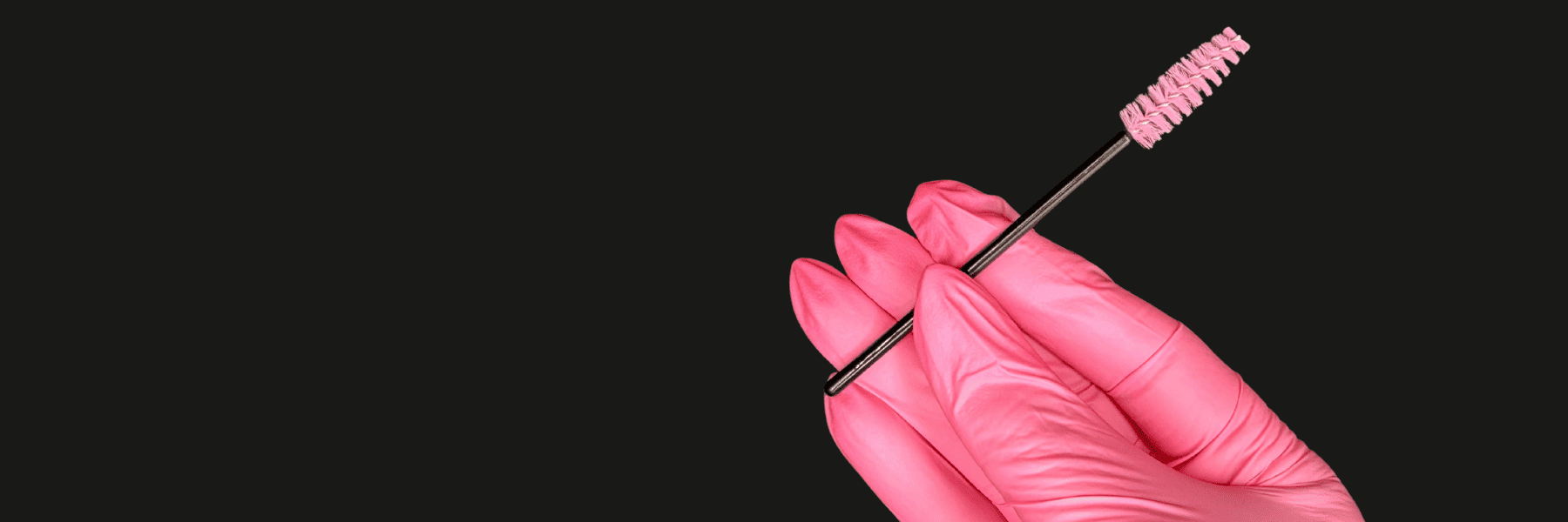 esthetician holding brow and lash brush