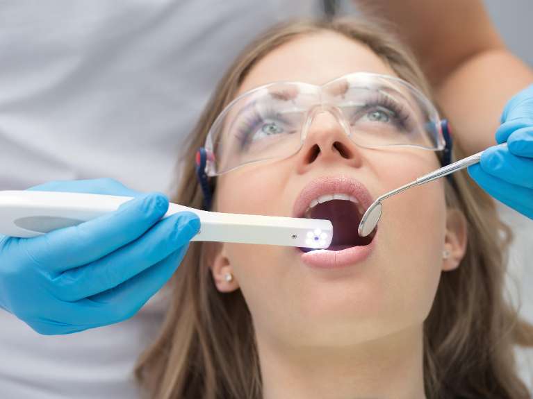 dental exam sweetwater | dentist using intraoral camera with patient